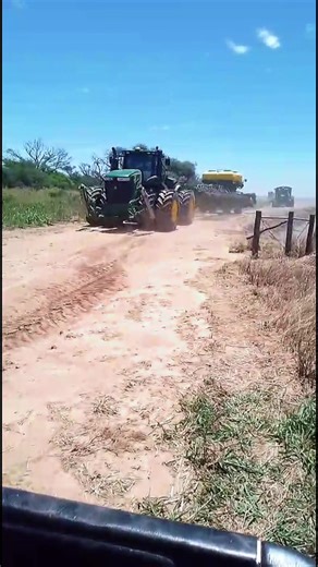 John Deere Tractors Working on the Farm