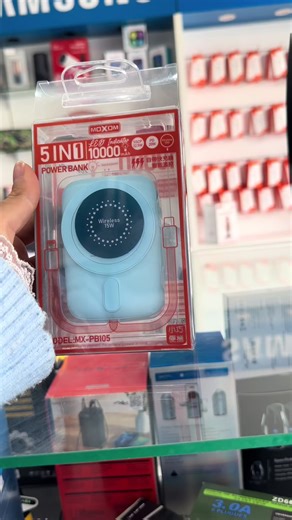 Promate PowerMag-10Pro 10000mAh magnetic wireless charging power bank in blue. It features 5-in-1 charging capabilities, including 15W wireless, 22.5W QC 3.0, and 20W Power Delivery (PD) ports. The device has a 10,000mAh capacity to keep multiple devices charged on the go. It supports charging up to three devices simultaneously. The power bank can transform into a stand for a phone due to a built-in magnet. #powerbank#wirless