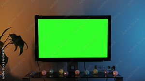 LcD smart TV screen with a blank green background in the living room. Chroma key screen for advertising.