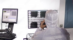 scientist working at a computer in the laboratory. discussion with a colleague working issues.