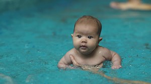 Little baby learning to swim in a pool - Free Stock Video