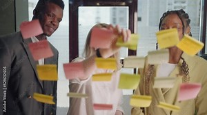 teamwork and brainstorming in in office of big company, portrait of workers through post-it notes