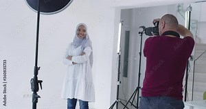 Photographer in photo studio shooting traditional muslim model