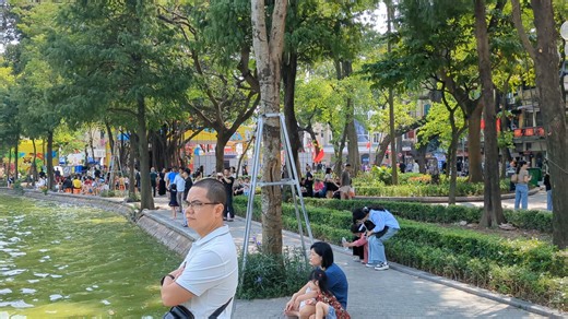 A busy weekend walking around Hoan Kiem Lake in Hanoi. One of the more popular things to do in Hanoi. More ideas in my linked guide below. #hanoitrip #hanoivietnam #hanoitravel #vietnamtravel | Anthony in Vietnam