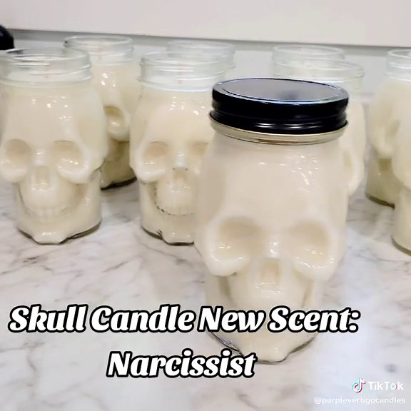 Narcissist fragrance is a seductive blend of warm, woodsy Egyptian musk and enchanting patchouli spiced with the subtle sweetness of cinnamon, orange blossom, and hints of anise. Limited quantities available! Each jar comes with an extra lid with hole for your straw, jars are reusable! #skullcandles #halloween #halloweendecor #viralproduct #viraltiktok #skullcandle #labordaysale #candle #candles #halloweencandle