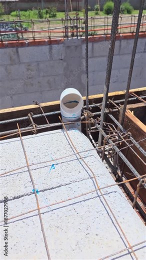Plumbing rough-in during concrete slab preparation, detail of sanitary pipe penetration in floor joist system
