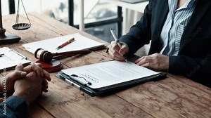 Attorney gives the client a pen to sign a contract admitting fraud, lawyer admits a fraud case in which client is a victim and will sue defendant who is a commercial partner. Fraud litigation concept.