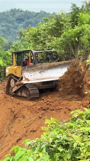 Breaking New Ground: Bulldozer Clears a Path Through the Mountain