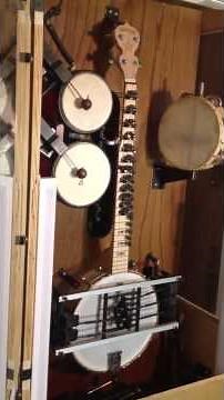 Coin operated automatic banjo playing machine