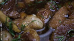 Cooking in nature a traditional Romanian recipe, pig alms, made from pork in a cauldron with lots of greens. The food is juicy and causes appetite. Stock Video