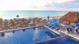 Enjoy the view of the beach from the tranquil infinity pool, refresh yourself with a tropical drink by the pool, and relax at the spa while the kids splash around in Treasure Island Water Park at the Seadust Cancun Family Resort. | Sunwing Vacations