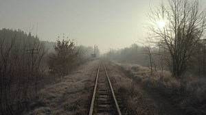 Drone flying over an old narrow gauge railway in the early morning. Aerial view of the railway tracks