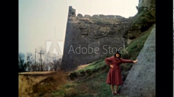 Woman tourist visiting epic medieval landmark castle bastion. Majestic defensive walls historical building outdoor. Tourism by ancient monument. Archival vintage color film. Retro archive 1980s Crimea