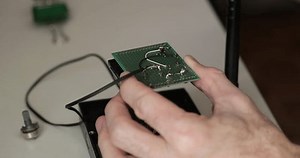 Expert hands performing detailed soldering on PCB. Extreme close-up of microelectronics components and perfect solder joints. High-tech repair process with focus on quality and precision.