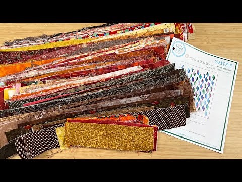 The STUNNING Shift quilt is made with leftover 2 1/2" strips or a Jelly Roll and background fabric!