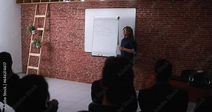 Mature woman coach explaining new business project at meeting event - Speech, seminar and coaching concept