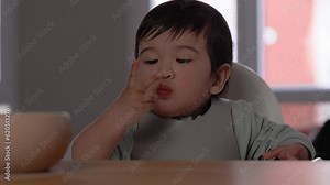 Mom spoon-feeds her baby. Introduction of complementary food, good nutrition, baby food