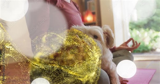 Bokeh coming from left starting gold swirls while woman meditating with dog looking for calm