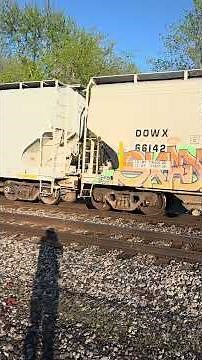 CN 2907, 3208 Westbound train: XOMX hoppers, QTTX depressed flat, BNSF FLEXIBEAM flat, autoracks
