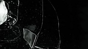Super Slow Motion Shot of Breaking Real Glass at 1000 fps. Isolated on Black Background.