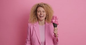 Optimistic Beautiful Woman Curly Hhair Holds Stock Footage Video (100% Royalty-free) 1073125898 | Shutterstock