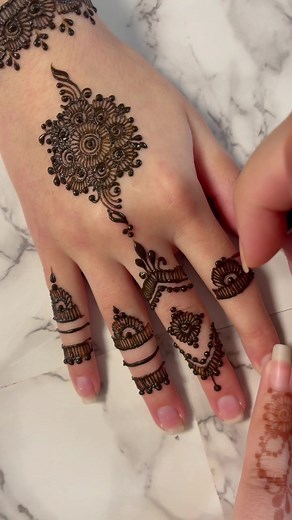 Applying Intricate Henna Designs on Hands