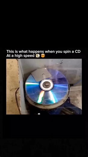 what if on Instagram: "When you spin a CD at insane speeds (up to 4,000 RPM): ✨ Rainbow colors burst out from light diffraction 💿 The disc melts into a perfect swirl of color 🌊 The tiny pits on its surface look like rippling waves 🌪 Light reflects in a hypnotic, spinning aura 💥 And finally—centrifugal force shatters it into thousands of pieces! Who knew a simple CD could turn into such a spectacle? #ScienceFacts #TechTrivia #PhysicsInAction #CDexplosion #StrongMotivationCircle #MindBlown #Re
