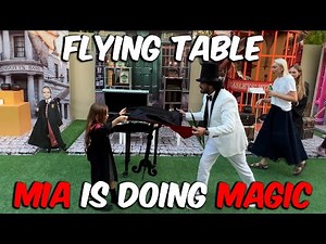 Mia is doing flying table magic trick