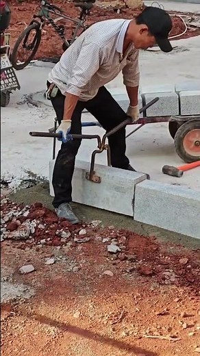 The process of installing curbstones using an ingenious tool