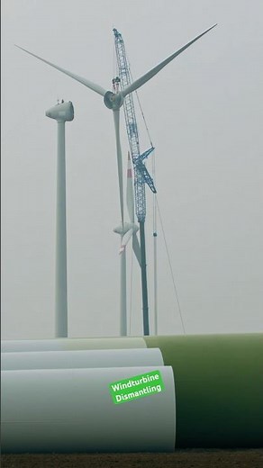 The huge rotor of an Enercon E-66 wind turbine is being lowered by a crane 🏗️