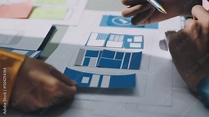 UX developer and ui designer brainstorming about mobile app interface wireframe design with customer breif and color code. business working