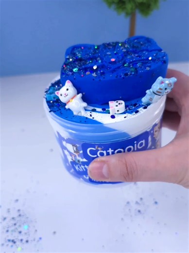 Catopia Slime Kit! Blue and white slime scent with a vanilla buttercream fragrance. Comes with a clay catface topper that mixes into the slime. Cute cat charms and glitter comes with it, as well as spray activator #catslime #slimekits #imaginationharvestslimes #cuteslime #butterslimekit