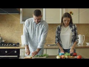 Happy young couple cooking breakfast together in the kitchen eartly morning