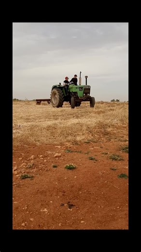 Operating an Older Green Tractor in the Field