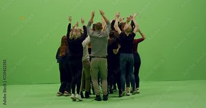 GREEN SCREEN CHROMA KEY Back view group of young people dancing and jumping with hands in the air. 4K UHD ProRes 4444