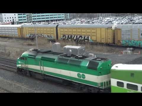 GO Transit trains meet CN X276 autorack train with BC Rail 4652 engine at Pickering station.