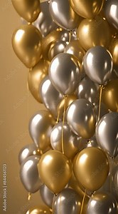 Flying gold and silver balloons, on a faded gold background