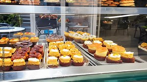 display of various pastries and desserts in a bakery shop window