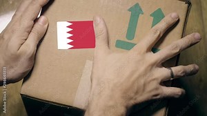 Labeling carton with the Bahraini flag sticker. Import or export in Bahrain related clip