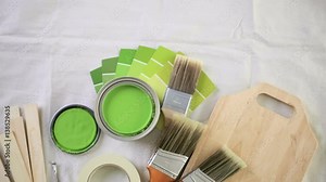 Paint in metal paint can and painters tools on a canvas drop cloth