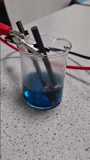 Electrolysis of copper sulfate solution using graphite electrodes.