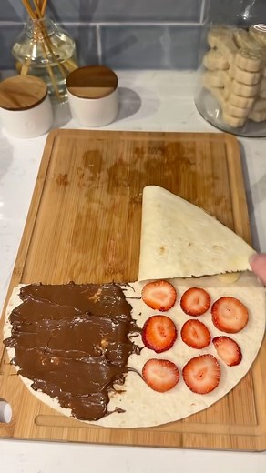 the easiest fruit dessert wrap you’ll ever make 🍓🍌🍫😍 Ingredients: 4 strawberries (sliced) 1 banana (sliced) 1 burrito sized @missionfoodsus tortilla 1 scoop @nutella 1 scoop @skippybrand creamy peanut butter 1 tbs butter Instructions: Slice tortilla down the middle halfway and place strawberries, banana, nutella, and peanut butter as shown. Fold wrap inward and grill in butter on medium-high heat for 1-2 minutes on each side. Slice down the middle and enjoy! 😋 | Ashley Markle