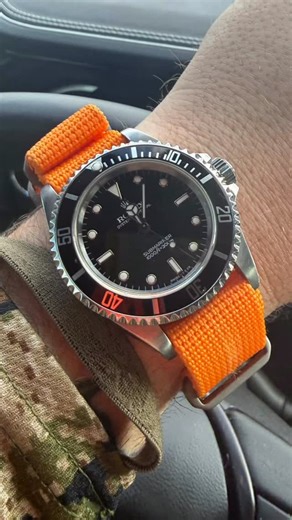 Prometheus Design Werx on Instagram: "PDW Ti-Ring (NATO-style) Strap in orange. Unique to our watch straps is our development of all titanium custom buckles, rings and hardware. No rust, no corrosion, no magnetic interference with any strap worn compasses. Photo credit: @quaddefense #watchstraps #natostraps #watchesofinstagram #rolex #edc"