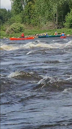 Whitewater and canoe paddlers in the distance