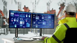 Engineer Using PC In Car Factory Automated Assembly Line