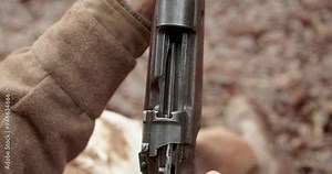 Close Up of Hands cocking rifle gun to reveal empty chamber, World War 2, Static Shot