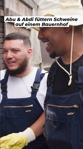 Abu & Abdi are feeding pigs on a farm