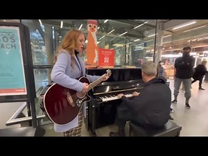 Girl Walks Through The Station With A Guitar....