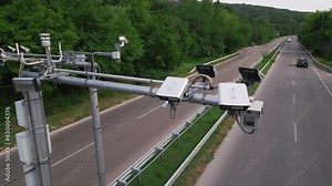 Cameras and speed control radars along a busy highway monitor and record speeding violations.
