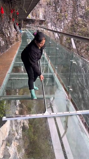 Asian Technology on Instagram: "Watch as workers meticulously clean a stunning transparent glass bridge stretching between two majestic mountains. Each careful sweep and wipe transforms the glass into a crystal-clear window to the breathtaking view below. The satisfying ASMR sounds of the cleaning process, paired with the serene surroundings, make this an unexpectedly mesmerizing experience. It's a fascinating glimpse into the harmony of nature and human effort, where precision meets awe-inspiri